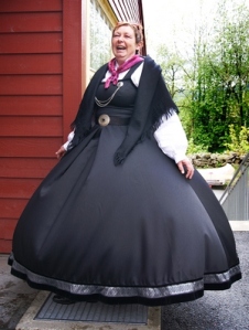 Bodil Hjøllo Solheim in National Costume with wind under her rock. 